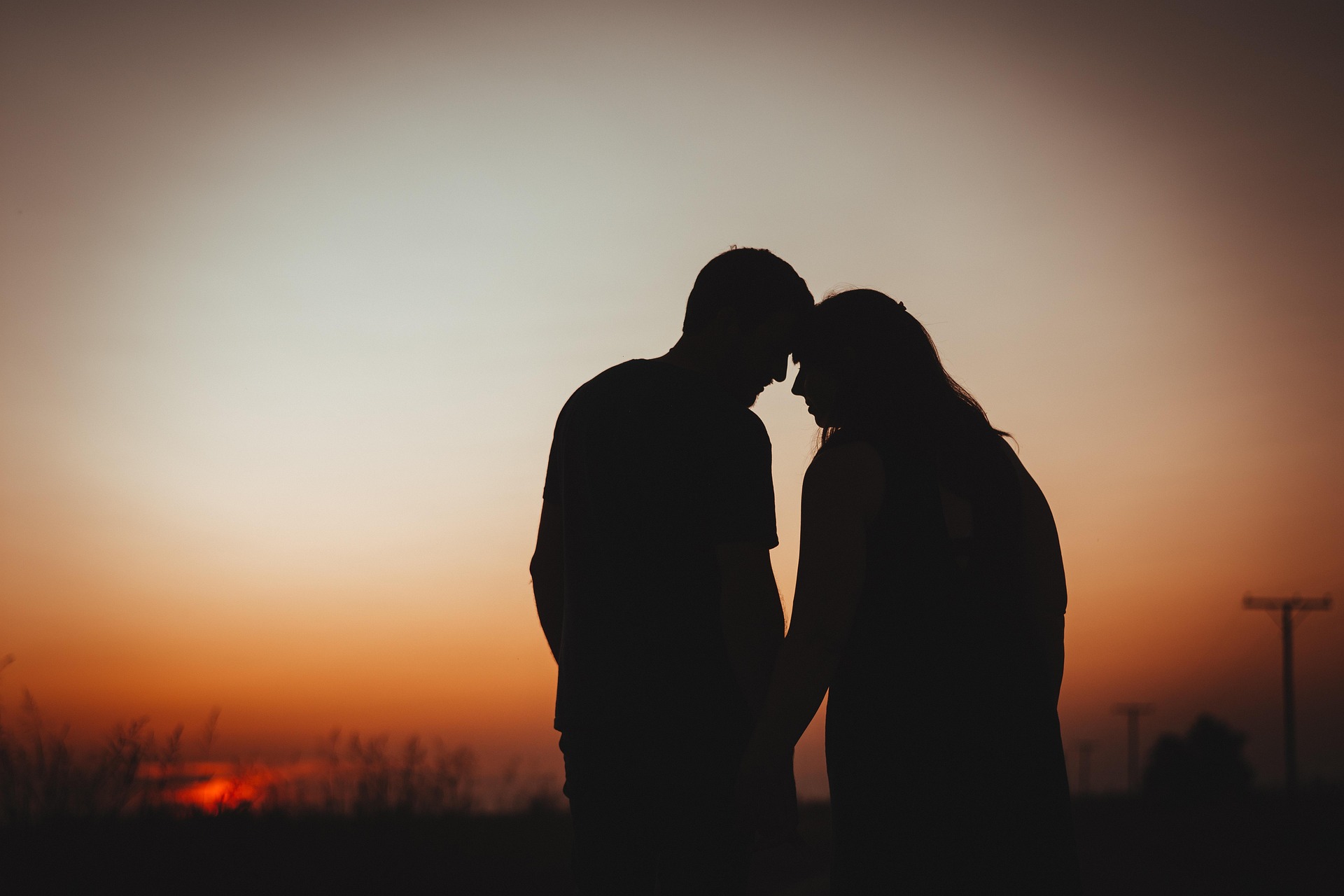 A couple in love against the backdrop of a sunset